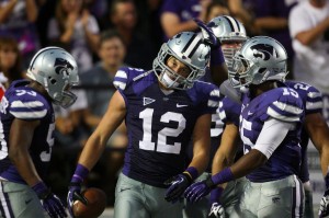 Sep 7, 2013; Manhattan, KS, USA; Kansas State Wildcats defensive back Ty Zimmerman (12) is congratulated by teammate Randall Evans (15) following an interception return for a touchdown against the Louisiana-Lafayette Ragin Cajuns at Bill Snyder Family Stadium. Credit: Scott Sewell-USA TODAY Sports