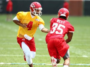 May 25, 2014; Kansas City, MO; Quarterback Jonathan Jennings (4) hands off to running back Charcandrick West (35) on Day Two of the Chiefs rookie minicamp. Credit: KCChiefs.com.