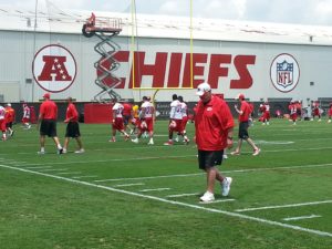 June 3, 2014; Kansas City, MO; Chiefs coach Andy Reid and players leave the practice field at the conclusion of OTAs at the team’s training facility. Credit: Teope 