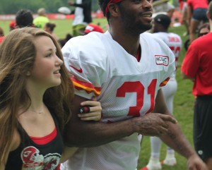 July 26, 2014; St. Joseph, MO; Chiefs fan and Kids Club member Taylor Lancaster walked off the practice linked arm-in-arm with defensive back Marcus Cooper as part of the team's Family Fun day at training camp.