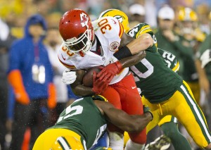 Aug 28, 2014; Green Bay, WI; Chiefs running back Joe McKnight (30) carries the ball against Packers linebacker Andy Mulumba (55) and defensive back Tanner Miller (40) at Lambeau Field. Credit: Jeff Hanisch-USA TODAY Sports