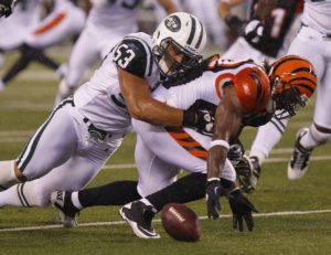 Aug 21, 2011; East Rutherford, NJ; Then-Jets linebacker Josh Mauga (53) hits then-Bengals running back Cedric Benson (32) at New Meadowlands Stadium. Credit: Tim Farrell/The Star-Ledger via USA TODAY Sports