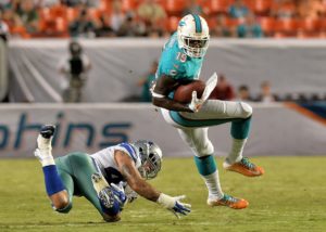 Aug 23, 2014; Miami Gardens, FL; Then-Dolphins wide receiver Armon Binns (19) eludes Cowboys linebacker Keith Smith (43) at Sun Life Stadium. Credit: Steve Mitchell-USA TODAY Sports
