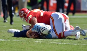Sep 7, 2014; Kansas City, MO; Titans quarterback Jake Locker (10) is sacked by Chiefs defensive end Mike DeVito (70) and outside linebacker Justin Houston (50). Credit: Denny Medley-USA TODAY Sport