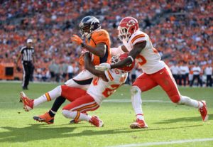 Sep 14, 2014; Denver, CO; Chiefs cornerback Chris Owens (20) and strong safety Eric Berry (29) tackle Broncos wide receiver Emmanuel Sanders (10) at Sports Authority Field at Mile High. Credit: Ron Chenoy-USA TODAY Sports