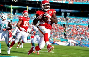 Sep 21, 2014; Miami Gardens, FL; Chiefs running back Knile Davis (34) scores a touchdown against the Dolphins at Sun Life Stadium. Credit: Brad Barr-USA TODAY Sports