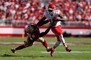 Oct. 5, 2014; Santa Clara, CA; Chiefs running back De'Anthony Thomas (13) holds off 49ers safety Antoine Bethea (41) on a touchdown run at Levi's Stadium. Credit: Kelley L Cox-USA TODAY Sports