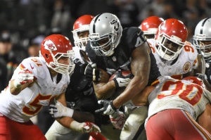 Nov. 20, 2014; Oakland, CA; Chiefs defenders gang tackle Raiders fullback Marcel Reece (45) during the fourth quarter at O.co Coliseum. Credit: Kyle Terada-USA TODAY Sports