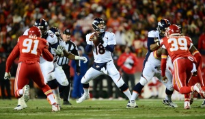 Nov 30, 2014; Kansas City, MO;  Broncos quarterback Peyton Manning (18) throws a pass in the first quarter against the Chiefs at Arrowhead Stadium. Credit: Ron Chenoy-USA TODAY Sports