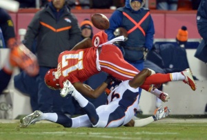 Nov 30, 2014; Kansas City, MO; Chiefs wide receiver Donnie Avery (17) fumbles as he is tackled by  Broncos free safety Rahim Moore (26) during the second half at Arrowhead Stadium. Credit: Denny Medley-USA TODAY Sports