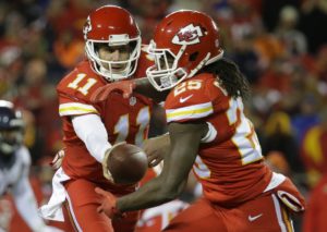 Kansas City Chiefs quarterback Alex Smith (11) hands off the ball to Kansas City Chiefs running back Jamaal Charles (25) in the first half of an NFL football game against the Denver Broncos in Kansas City, Mo., Sunday, Nov. 30, 2014. (AP Photo/Charlie Riedel)