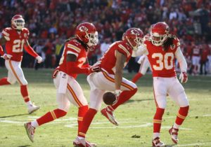 Kansas City Chiefs defensive back Jamell Fleming (30), strong safety Ron Parker (38) and cornerback Sean Smith (21) celebrate with defensive back Kurt Coleman, second from right, who intercepted the ball during the first half of an NFL football game against the San Diego Chargers in Kansas City, Mo., Sunday, Dec. 28, 2014. (AP Photo/Charlie Riedel)