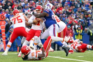 Kansas City Chiefs quarterback Alex Smith, left, is sacked by Buffalo Bills defensive tackle Marcell Dareus during the second half of an NFL football game, Sunday, Nov. 9, 2014, in Orchard Park, N.Y. (AP Photo/Bill Wippert)