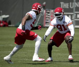 Kansas City Chiefs linebackers Tamba Hali (91) and Derrick Johnson participate in a drill during an NFL football organized team activity  Wednesday, May 27, 2015, in Kansas City, Mo. (AP Photo/Charlie Riedel)