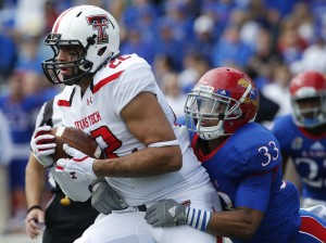 Texas Tech tight end Jace Amaro (22) is tackled by Kansas linebacker Cassius Sendish (33) after a completed pass in the first half of an NCAA college football game in Lawrence, Kan., Saturday, Oct. 5, 2013. (AP Photo/Orlin Wagner)