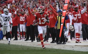 Kansas City Chiefs running back De'Anthony Thomas (13) was cheered into the end zone during a punt return for a touchdown against the Oakland Raiders during the first half of their NFL football game in Kansas City, Mo., Sunday, Dec. 14, 2014. (AP Photo/Reed Hoffmann)