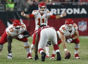 Aug. 15, 2015; Glendale, AZ; Chiefs quarterback Alex Smith (11) barks out signals while right guard Zach Fulton (73) and center Mitch Morse (61) settle in during the first-half preseason action against the Arizona Cardinals. (AP Photo/Rick Scuteri)