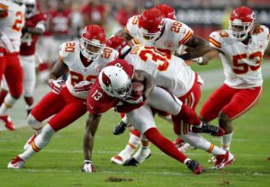 Aug. 15, 2015; Glendale, AZ; Chiefs safety Eric Berry (29) and cornerbacks Marcus Cooper (31) and Steven Nelson (20) combine to stop Arizona Cardinals wide receiver Jaron Brown (13) during the first half of the preseason opener. (AP Photo/Rick Scuteri)
