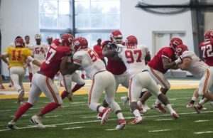 Aug. 3, 2015; St. Joseph, MO: Chiefs offensive lineman, in red, hold off their defensive counterparts during 11-on-11 drills at training camp. (Emily DeShazer/The Topeka Capital-Journal)