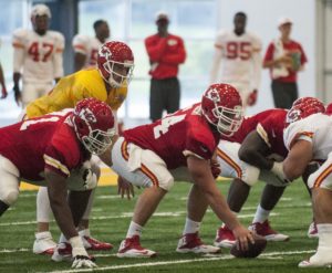 Aug. 2, 2015; St. Joseph, MO; Chiefs center Eric Kush (64)  prepares to snap the football to quarterback Alex Smith (11) during an indoor training camp practice at Missouri Western State University. (Emily DeShazer/The Topeka Capital-Journal)