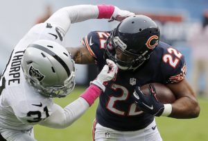 Oct. 4, 2015; Chicago; Bears running back Matt Forte (22) fights off Oakland Raiders cornerback Neiko Thorpe (31) during the first half at Soldier Field. (AP Photo/Charles Rex Arbogast)