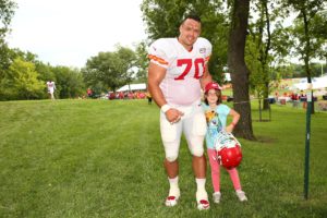Aug. 4, 2015; St. Joseph, MO; Chiefs defensive end Mike DeVito poses with a young girl from the Snowball Express during training camp at Missouri Western State University. (Photo courtesy of the Kansas City Chiefs)