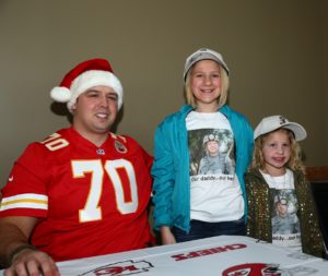 Dec. 11, 2014; Kansas City, MO; Chiefs defensive end Mike DeVito with children from Snowball Express at the Kansas City International Airport. (Photo courtesy of the Kansas City Chiefs)