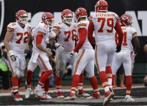 Dec. 6, 2015; Oakland; Kansas City Chiefs quarterback Alex Smith (11) celebrates with his offensive line after rushing for a touchdown against the Raiders at O.co Coliseum. (AP Photo/Ben Margot)