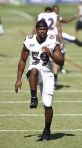 July 31, 2015; Owings Mills, MD; Baltimore Ravens linebacker Arthur Brown (59) warms up during training camp. (AP Photo/Gail Burton)