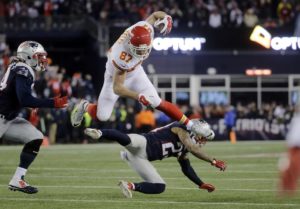 Jan. 16, 2016; Foxborough, MA; Kansas City Chiefs tight end Travis Kelce (87) leaps over New England Patriots safety Patrick Chung (23) in the first half at Gillette Stadium. (AP Photo/Steven Senne)