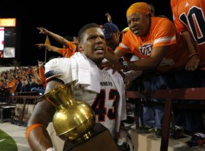 Sept. 19, 2015; Las Cruces, NM; UTEP defensive lineman Roy Robertson celebrates with fans holding the Brass Spittoon after the Miners defeated New Mexico State at Aggie Memorial Stadium. (AP Photo/Andres Leighton)
