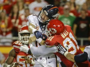 Sept. 17, 2015; Kansas City, MO; Chiefs outside linebacker Tamba Hali (91)] delivers a blow to Denver Broncos quarterback Peyton Manning (18) in the first half at Arrowhead Stadium. (AP Photo/Charlie Riedel)