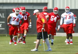 May 7, 2016; Kansas City, MO; Chiefs coach Andy Reid walks in front of players warming up Day One of rookie minicamp at the team's training facility. (Chris Neal/The Topeka Capital-Journal)