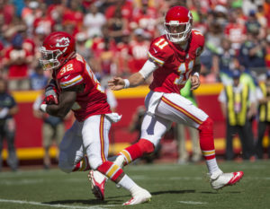 Chiefs quarterback Alex Smith hands off to running back Spencer Ware during the opening drive of the team's preseason game against Seattle on Saturday, Aug. 13 in Kansas City, Mo. (Emily DeShazer/The Topeka Capital-Journal)