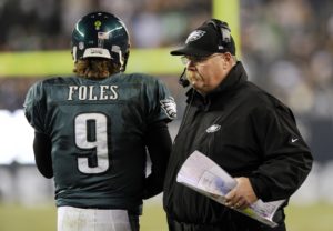 Philadelphia Eagles quarterback Nick Foles (9) walks past coach Andy Reid in the first half of an NFL football game against the Carolina Panthers, Monday, Nov. 26, 2012, in Philadelphia. (AP Photo/Michael Perez)
