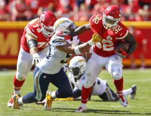 Kansas City's Spencer Ware, right, breaks a tackle by San Diego's Manti Te'o during the second half of Sunday afternoon's overtime win over the Chargers, 33-27, at Arrowhead. (Chris Neal/The Topeka Capital-Journal)
